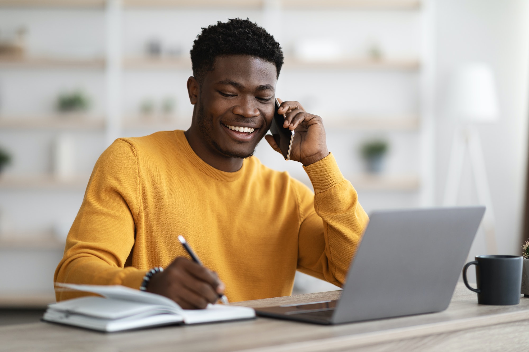 Happy black man freelancer working from home