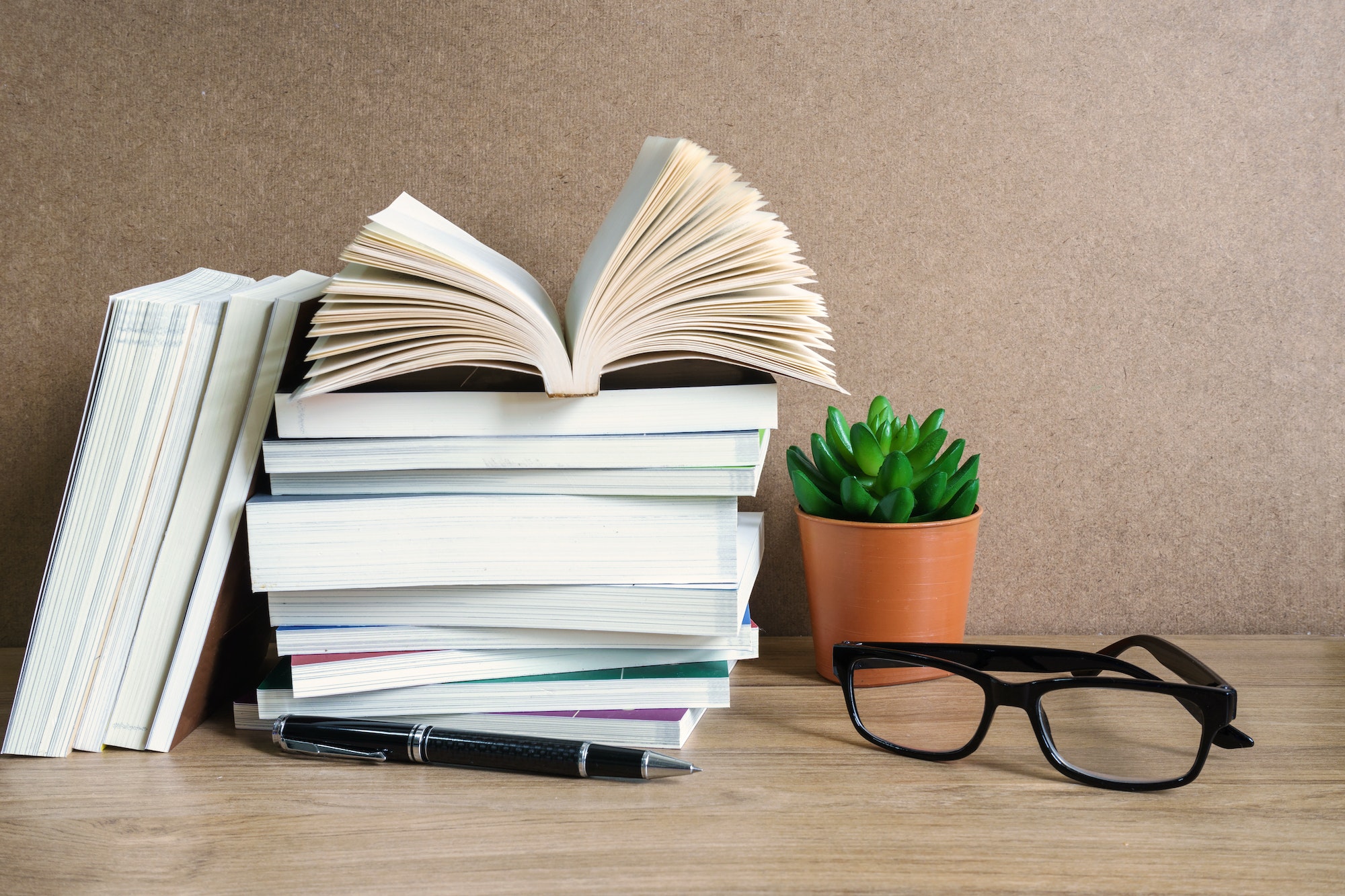 Stack of books on wooden table